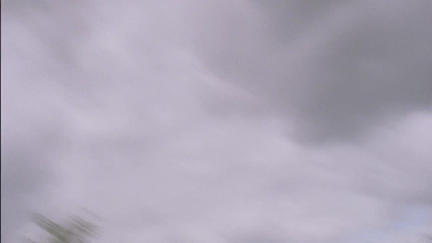 A dirt bike rider is taking his bike off a large jump