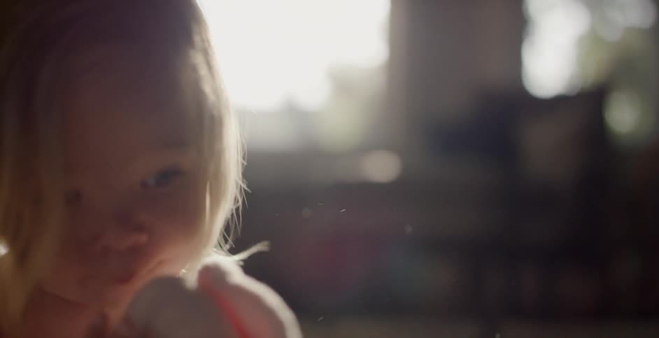 A toddler is playing on the floor with her stuffed animals
