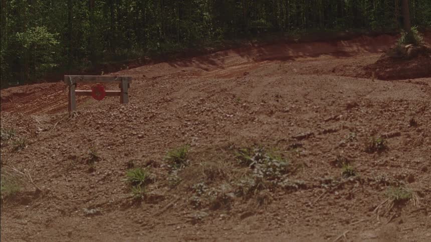 Motocross riders traverse a dirt course