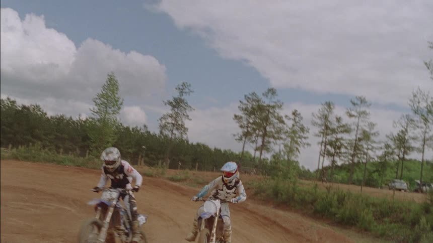 People racing on dirt bikes