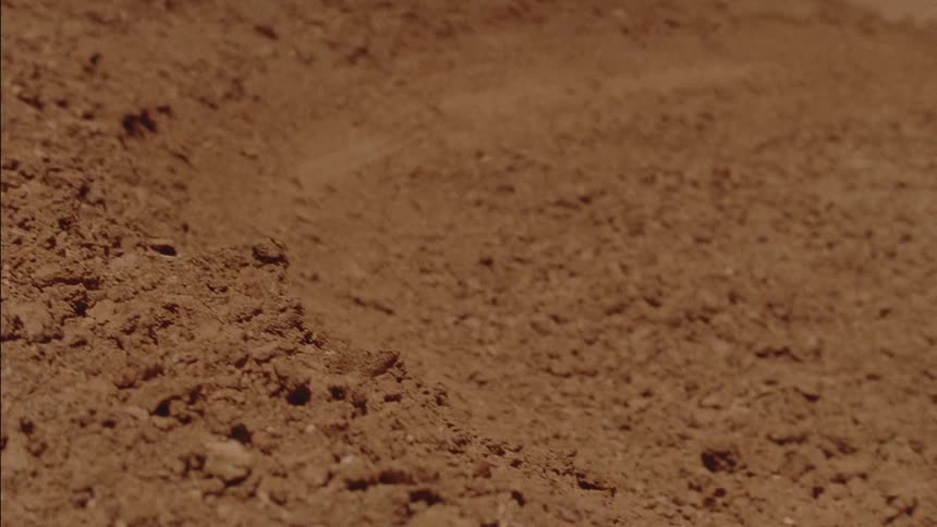 A motocross rider rides on a dirt course