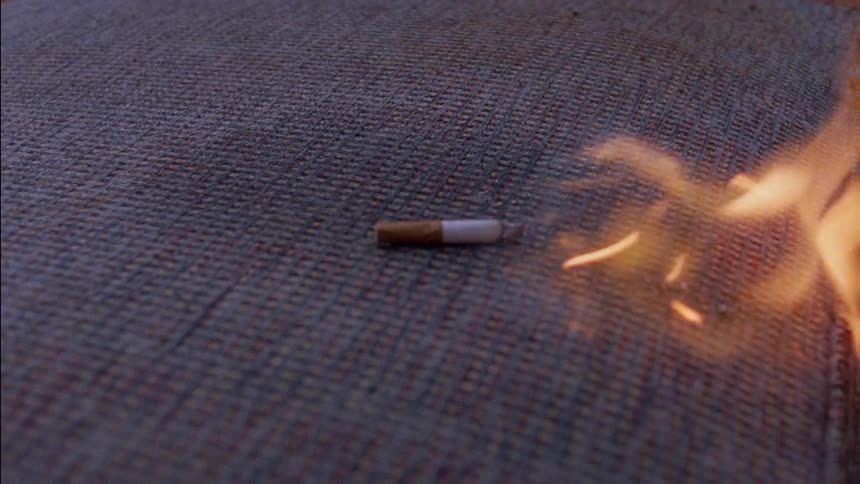 A cigarette ignites a fire on a couch