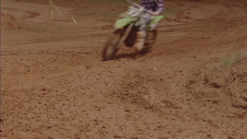 A man rides a dirt bike on a track