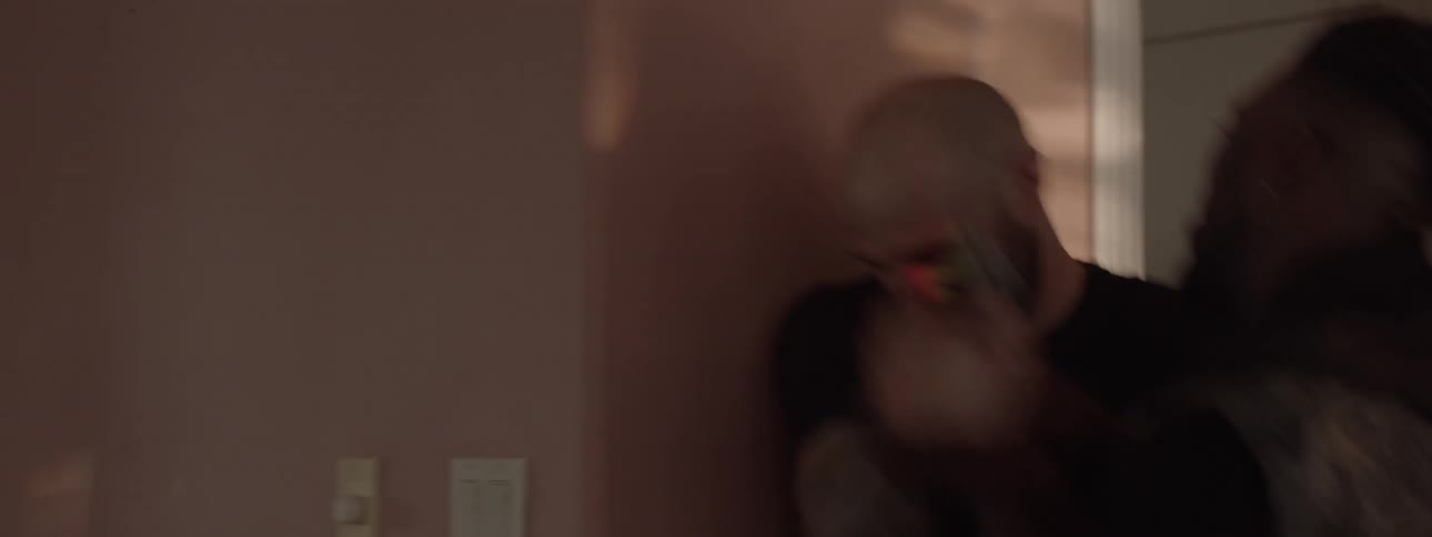 A man takes cover with a gun and fights someone