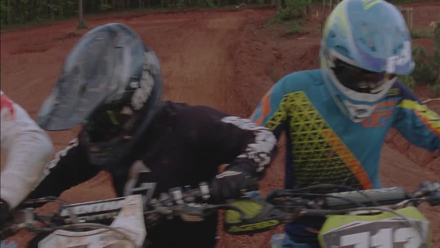 The people line up on their dirt bikes for a race