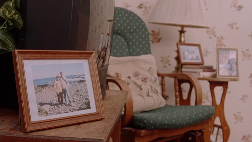 Family pictures are displayed in a living room