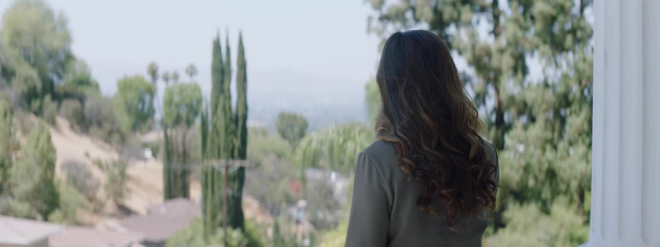 A woman is taking in the view from a balcony