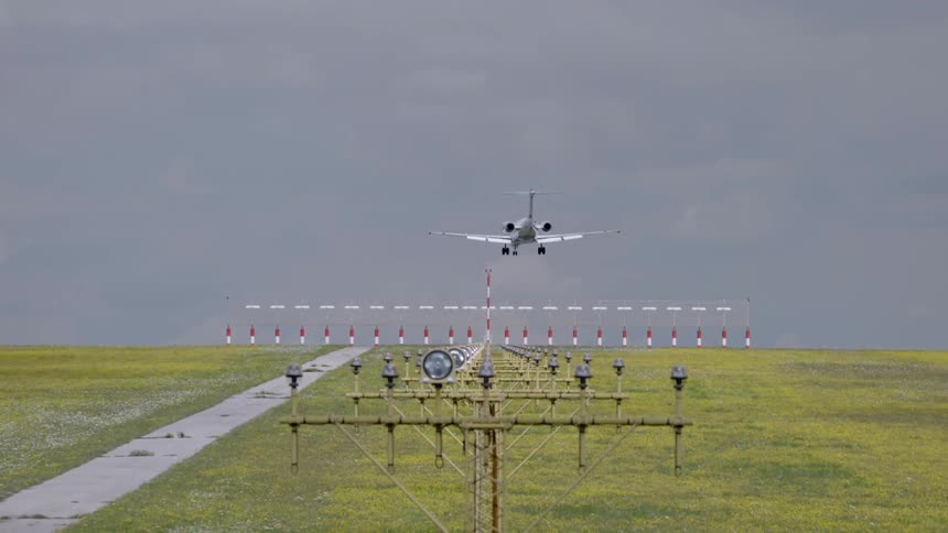 A plane descends to land on the runway
