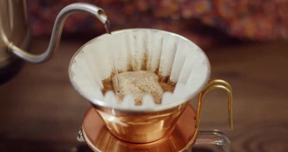 Water is pulled into a coffee press filter