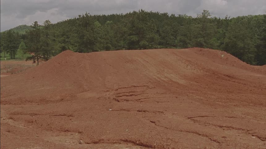 A person goes over a jump on a dirt bike