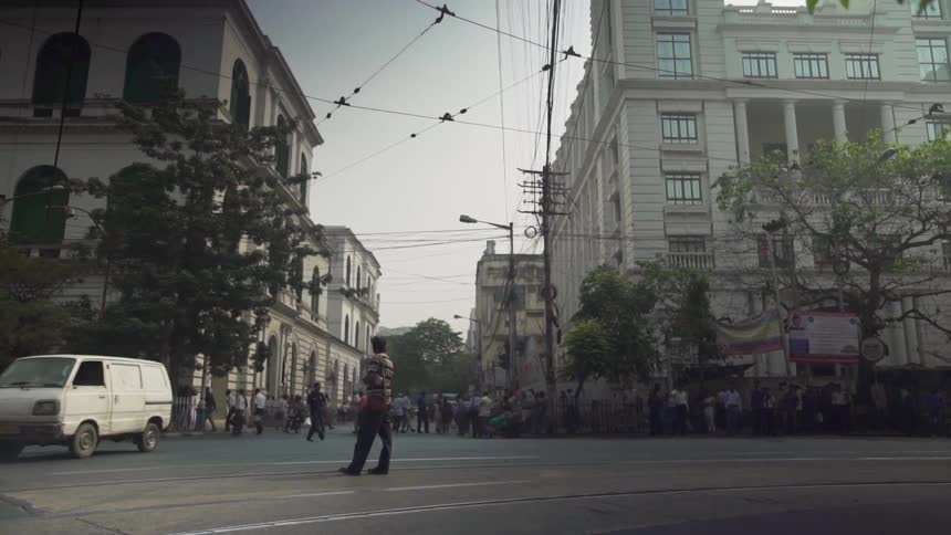 Crowds of people walking on sidewalk in busy city center