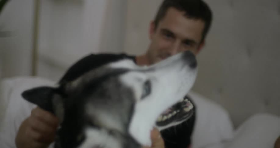 A couple are petting their dog