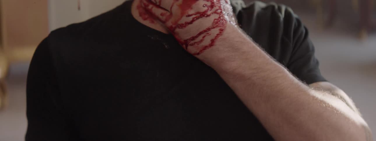 Bleeding man is punched again and slumps to the floor