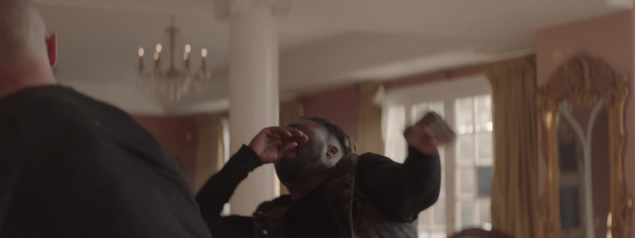 Two guys are fighting in the living room of a house