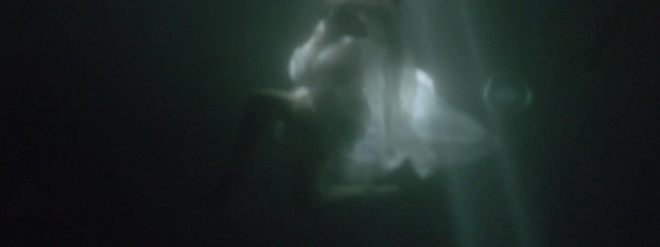 A woman in a dress is swimming in a lake