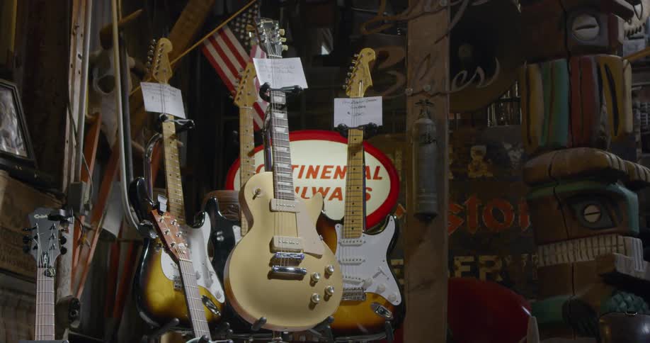 Guitars are hung up for display in a shop