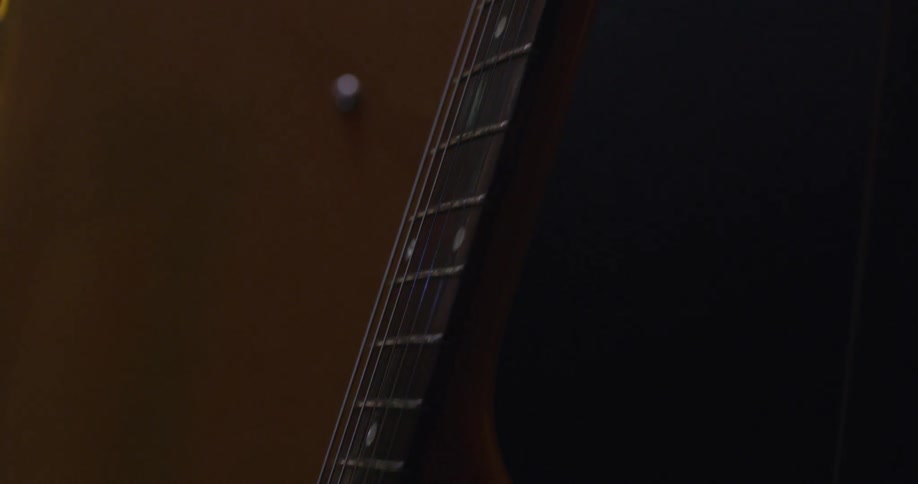 A guitar leaning on a stand