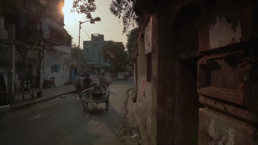 Pedestrians walk down a street in a town