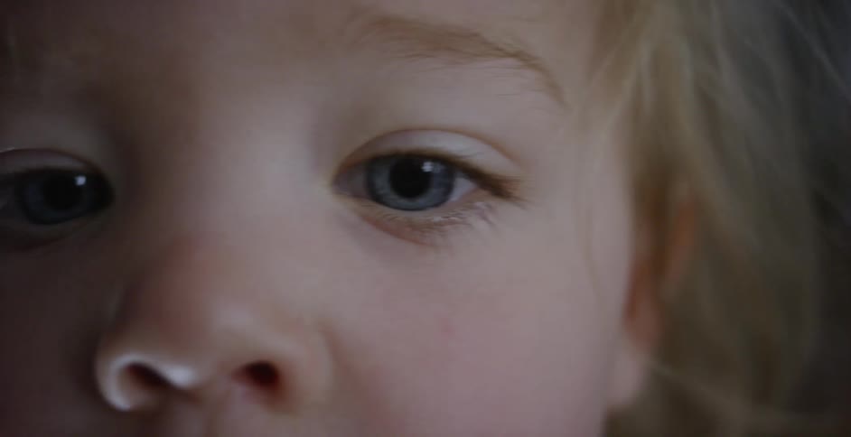 A child looks around smiling