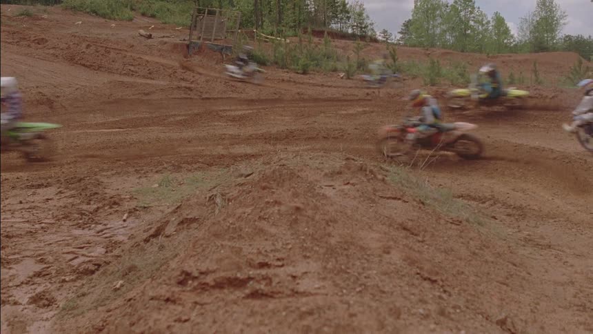 Motocross riders travese a dirt course