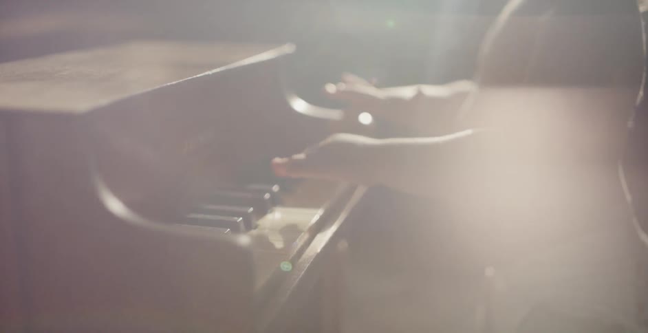 A baby in a diaper plays a toy piano
