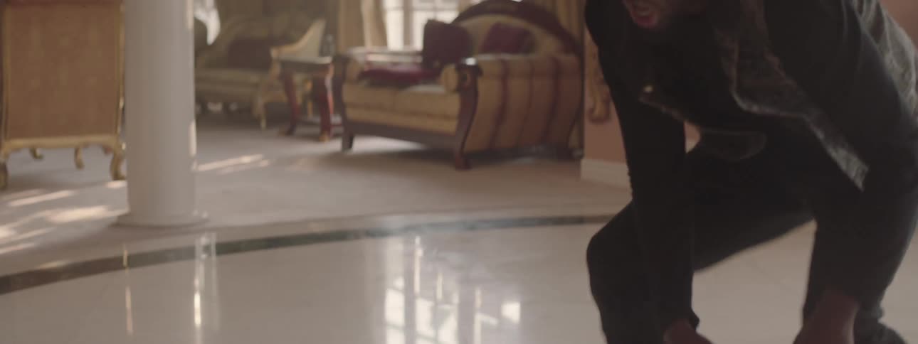 Two men are fighting in the living room of a house