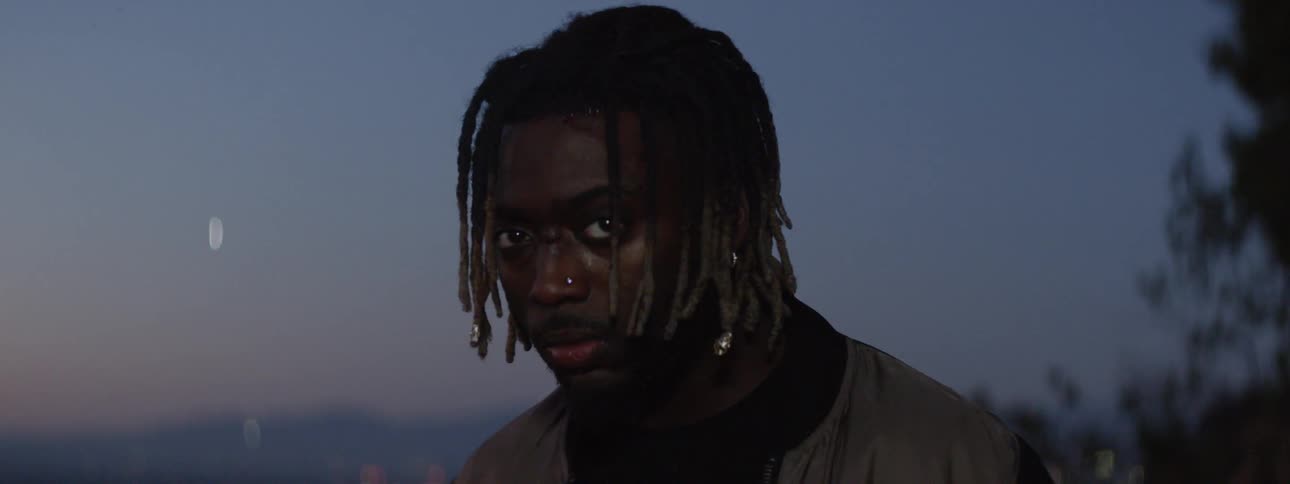 A man with a cut nose looks down and back up