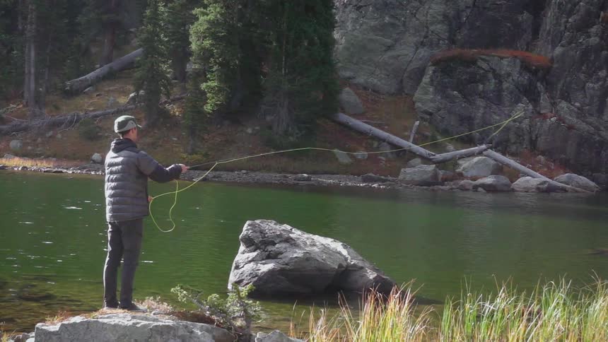 A man casts his line fly fishing