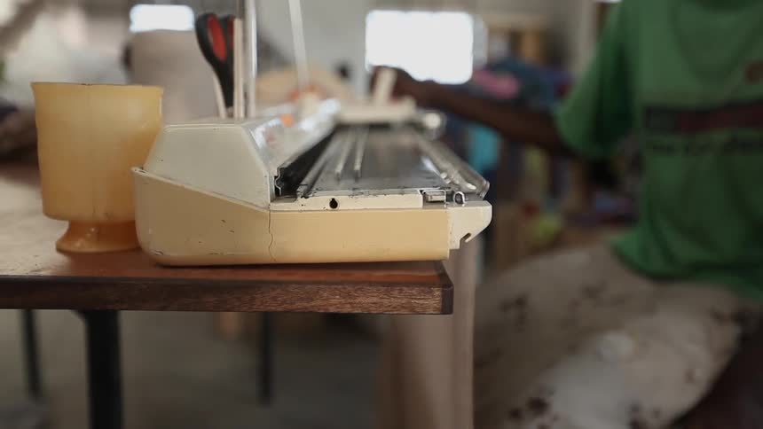 A person using a machine in a factory