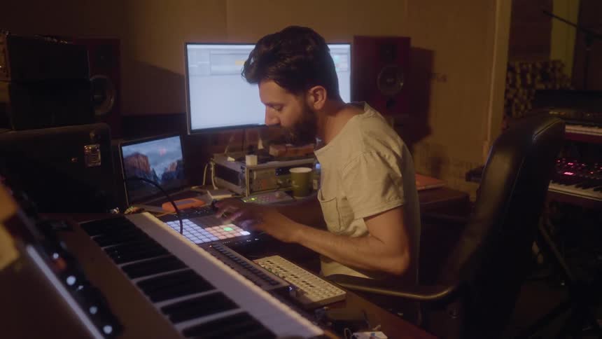 A man is working in his studio pressing buttons