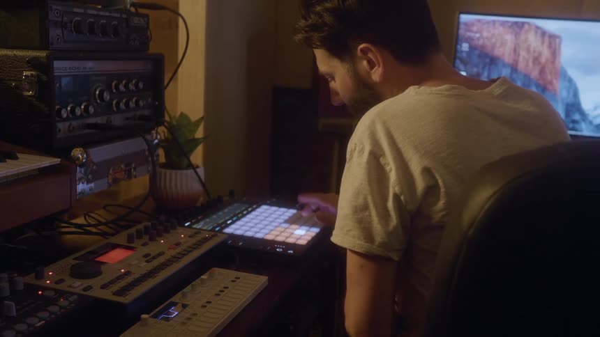 A man is working in a music studio