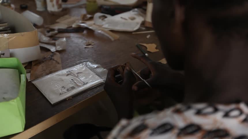 A woman cuts with a small pair of scissors