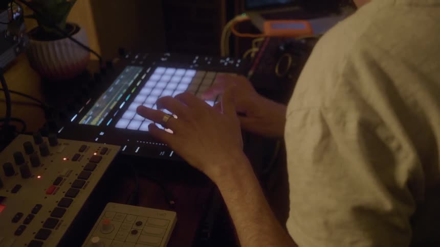 A man is working in the dark studio