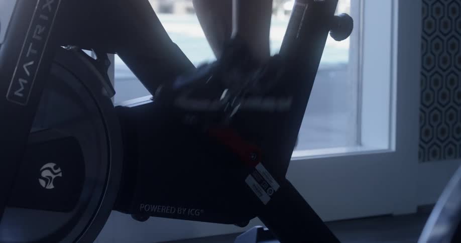 Person cycles on an exercise bike