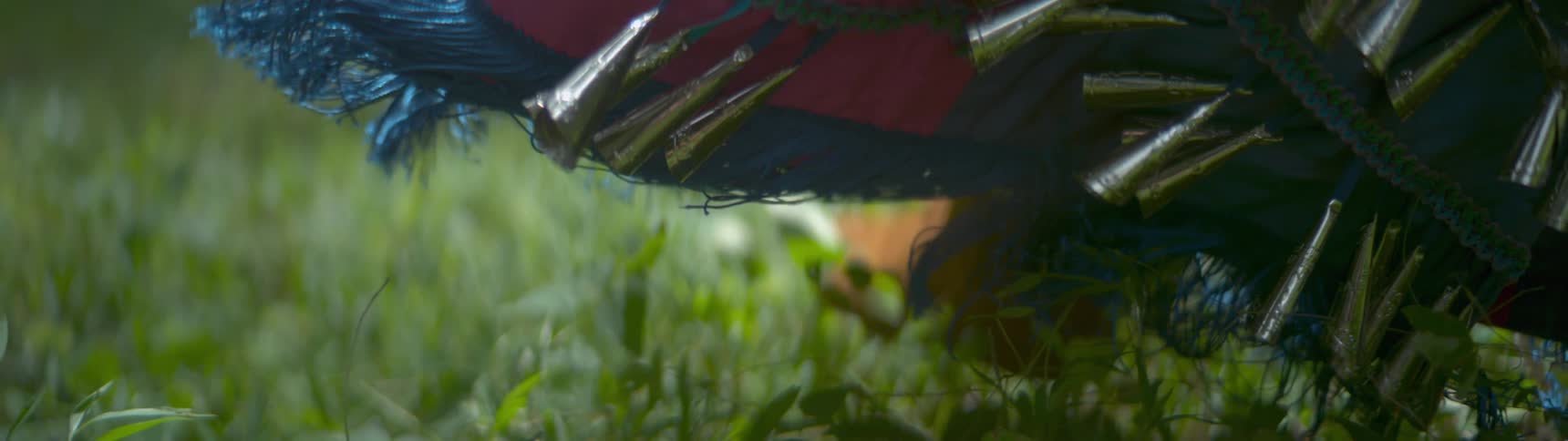 A person dances in the grass