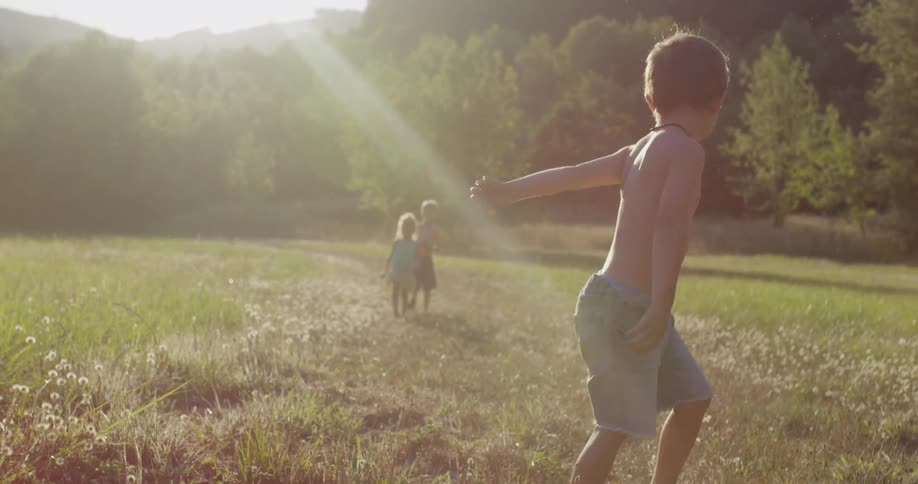 Children walk along the field
