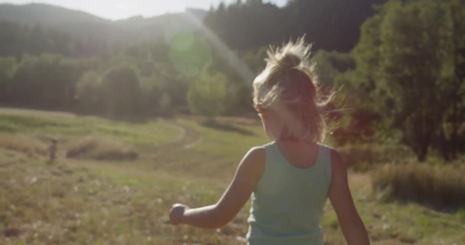 A child walks outside on a sunny day