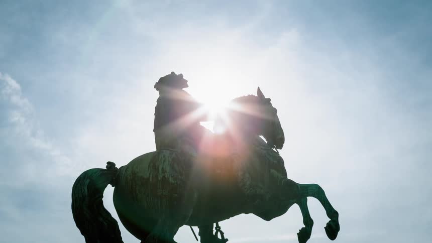 The statue of a man on a horse fills the skyline