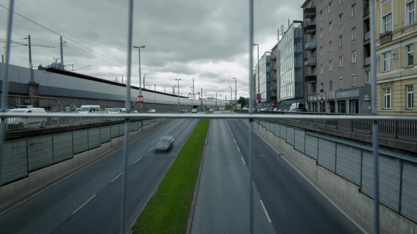 The cars travel along the expressway in the city