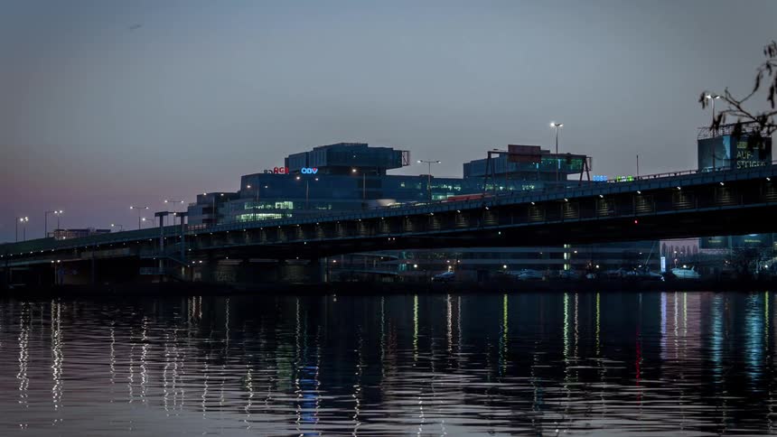 Time lapse of cars cross a bridge filmed from the water