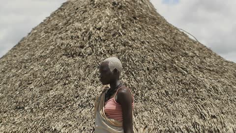 A person standing in front of a mound