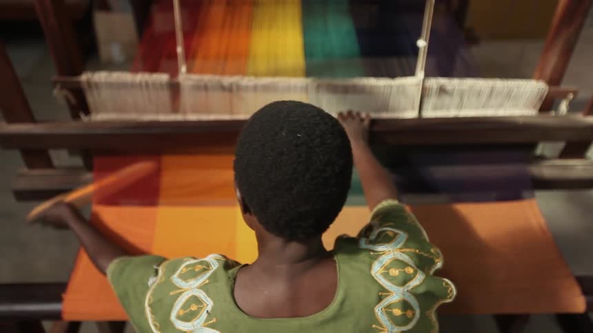Woman weaving at a loom