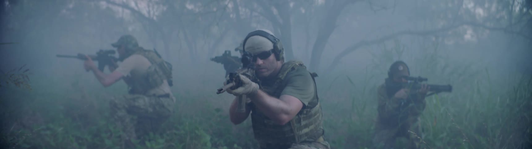 A group of soldiers search around the fog with rifles drawn