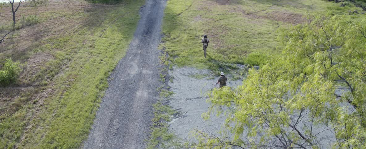 Two soldiers march along the field