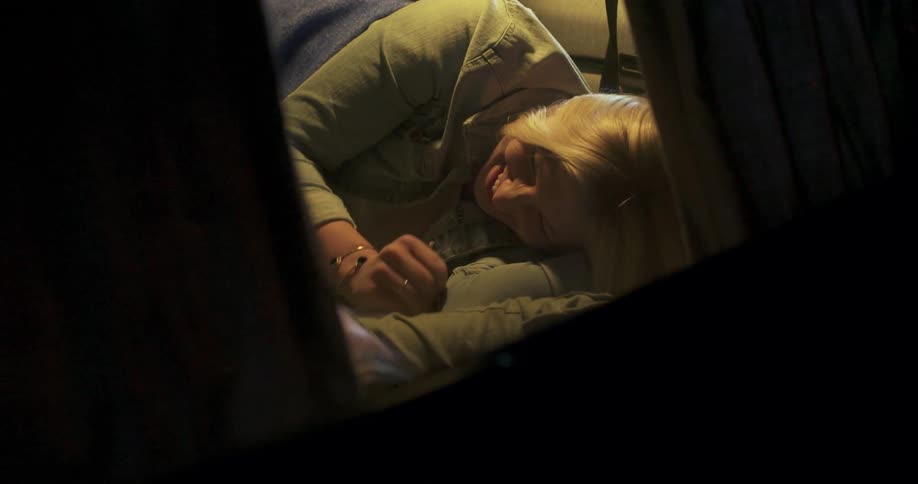 A man and woman lay in a cabin van