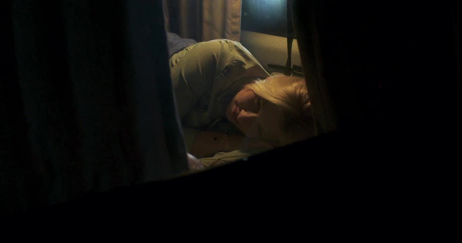 A man and woman lay in a cabin van