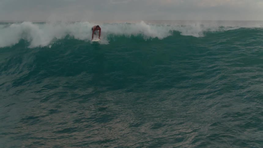 A man is surfing in the water