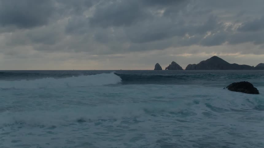 Waves rolling towards the shore on a cloudy day