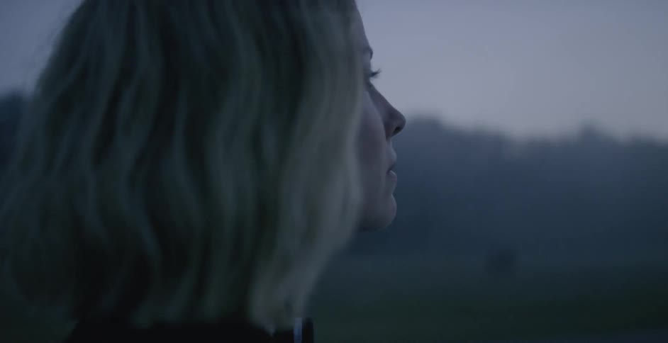 A woman walks outside on a foggy day
