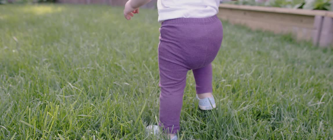 A child walks in the tall grass